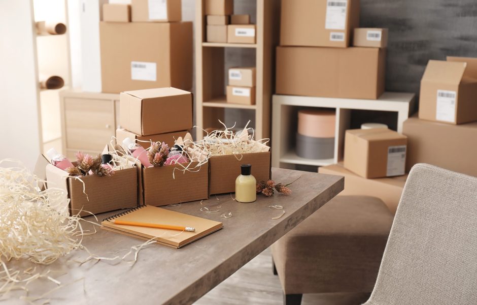 boxes filled with cosmetics being packaged on a table