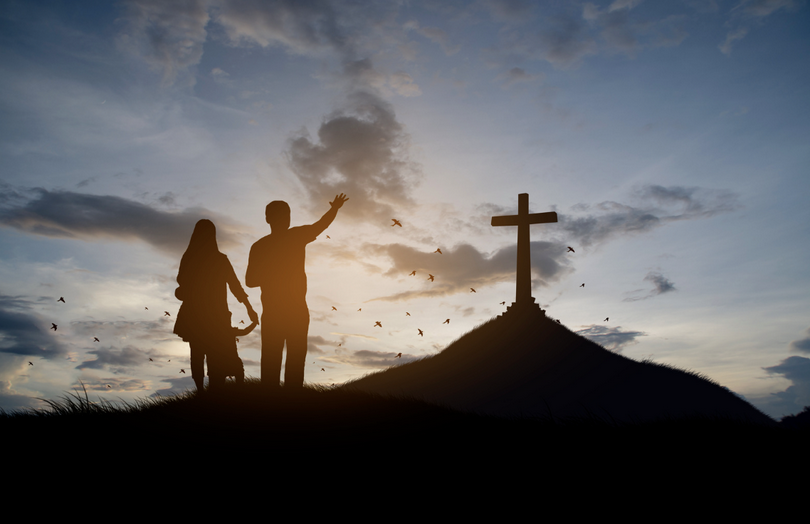 A Christian family stand with cross for worship God.